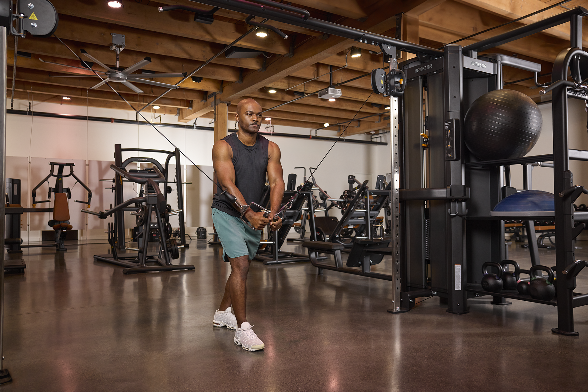 Precor Facility Strength RMS Person Working Out Cable Cross Over